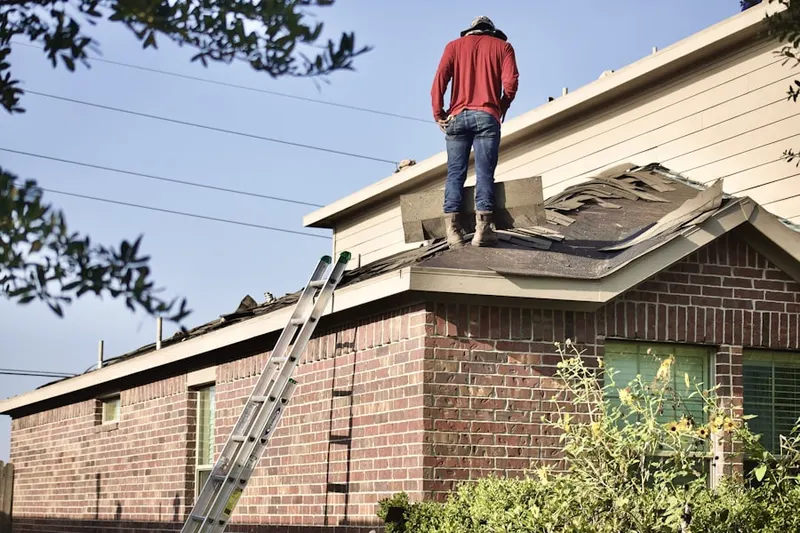 Professional roofer working on a residential roof in Hugo